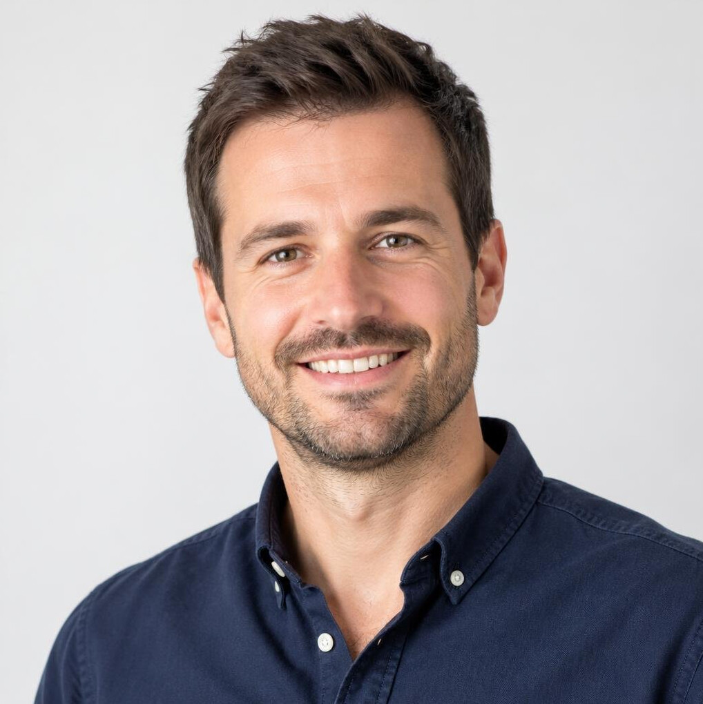 Portrait of a smiling man with short dark hair in a casual shirt